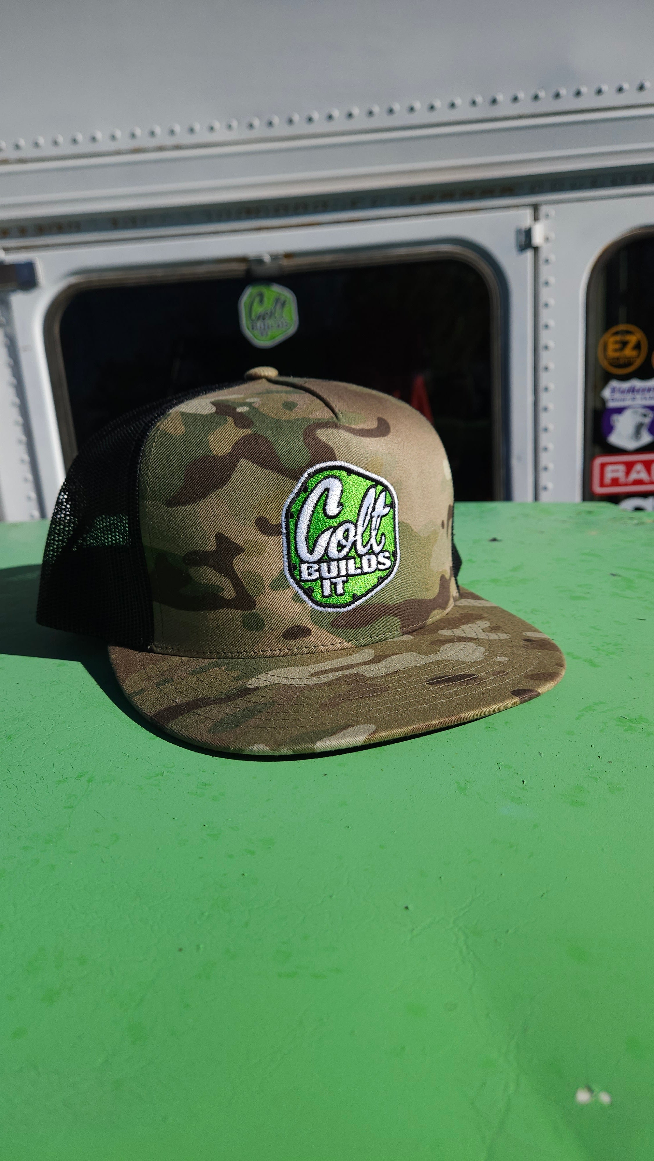 Colt Builds It light camouflage trucker snapback hat with embroidered logo on off-road rig